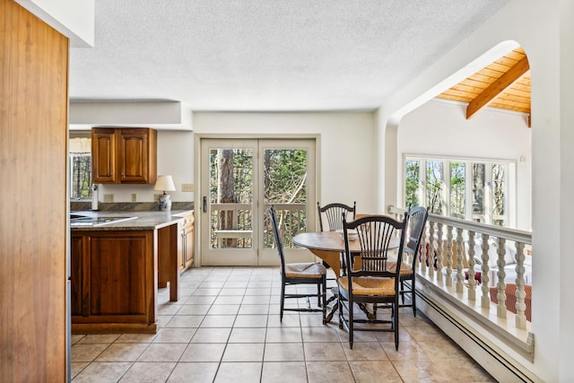 126 Middle Rd, Woolwich, ME 04579 - dining space with light tile patterned floors, a baseboard heating unit, a healthy amount of sunlight, and beamed ceiling