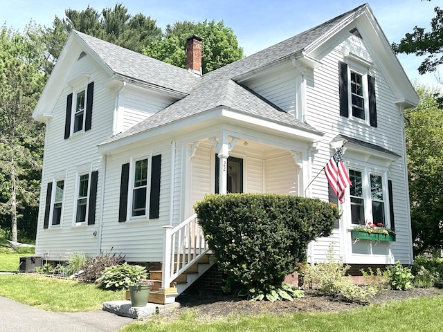 22 Mills Rd, Newcastle, ME 04553 - view of front facade with a chimney, roof with shingles, and a porch