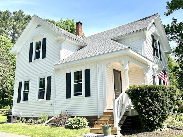 22 Mills Rd, Newcastle, ME 04553 - view of front of property with a chimney, roof with shingles, and a porch