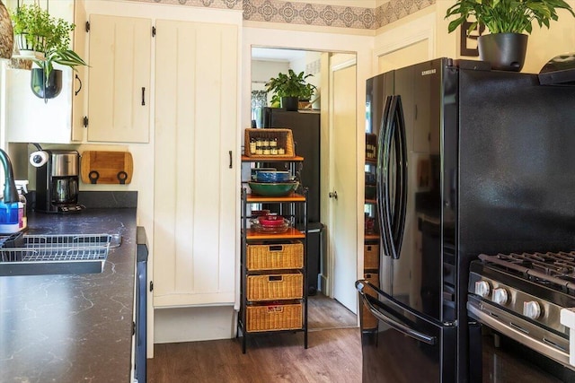 22 Mills Rd, Newcastle, ME 04553 - kitchen featuring dark wood-style floors, white cabinetry, stainless steel gas range, and freestanding refrigerator