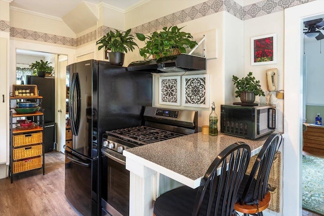 22 Mills Rd, Newcastle, ME 04553 - kitchen featuring stainless steel gas stove, ventilation hood, wood finished floors, and crown molding