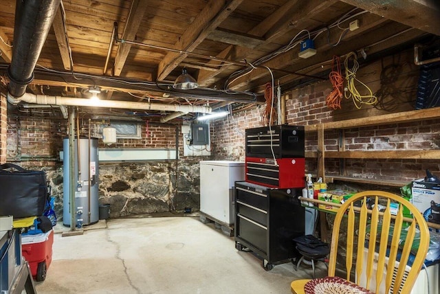 22 Mills Rd, Newcastle, ME 04553 - unfinished basement with water heater, brick wall, and refrigerator
