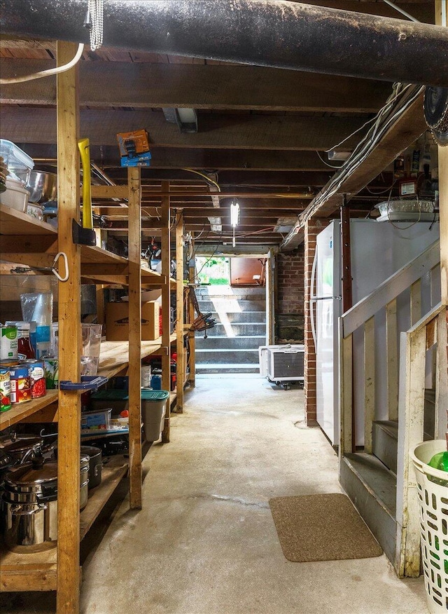 22 Mills Rd, Newcastle, ME 04553 - unfinished basement featuring stairway and freestanding refrigerator
