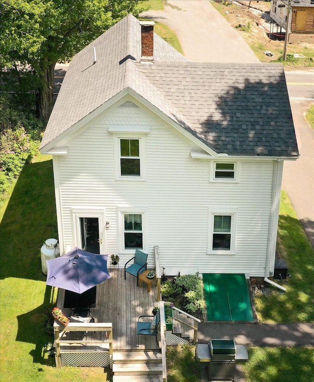 22 Mills Rd, Newcastle, ME 04553 - rear view of property featuring a shingled roof, a wooden deck, a chimney, and a yard