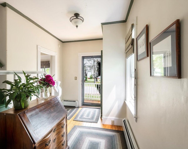 22 Mills Rd, Newcastle, ME 04553 - entrance foyer with a baseboard radiator, ornamental molding, wood finished floors, and baseboard heating