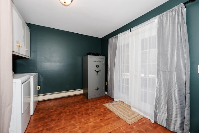129 Bailey Hill Rd, New Sharon, ME 04955 - clothes washing area featuring cabinet space, wood finished floors, washing machine and clothes dryer, baseboards, and a baseboard radiator