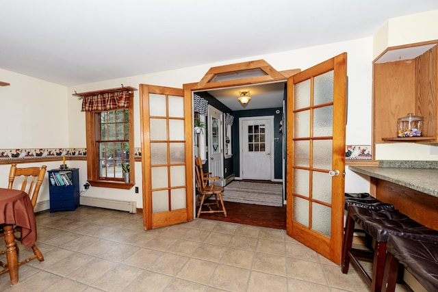 129 Bailey Hill Rd, New Sharon, ME 04955 - kitchen featuring a baseboard heating unit, french doors, and light tile patterned flooring