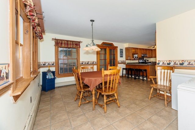 129 Bailey Hill Rd, New Sharon, ME 04955 - dining area featuring a notable chandelier, washer / clothes dryer, and light tile patterned floors