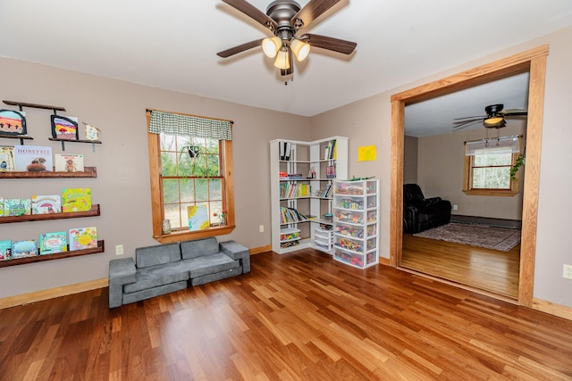 129 Bailey Hill Rd, New Sharon, ME 04955 - living area featuring baseboards, a ceiling fan, and wood finished floors