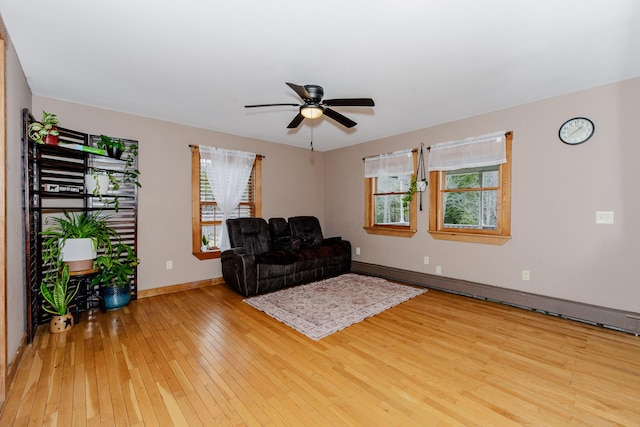 129 Bailey Hill Rd, New Sharon, ME 04955 - sitting room with wood-type flooring, a baseboard radiator, ceiling fan, and plenty of natural light