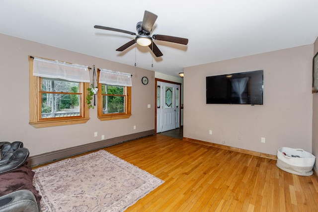 129 Bailey Hill Rd, New Sharon, ME 04955 - living area with a baseboard radiator, baseboards, light wood-style floors, and ceiling fan