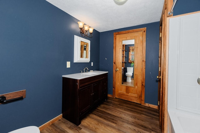129 Bailey Hill Rd, New Sharon, ME 04955 - full bathroom with toilet, wood finished floors, a textured ceiling, and baseboards