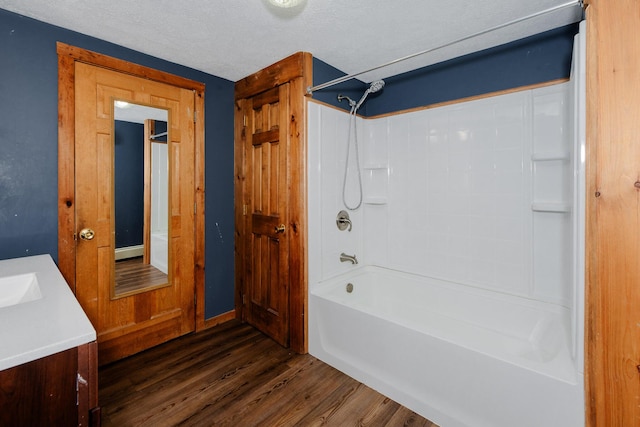 129 Bailey Hill Rd, New Sharon, ME 04955 - bathroom featuring wood finished floors, a textured ceiling, vanity, and  shower combination