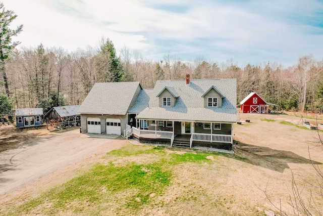 129 Bailey Hill Rd, New Sharon, ME 04955 - cape cod home with dirt driveway, covered porch, an outbuilding, a garage, and a barn