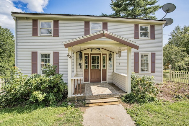 colonial home featuring fence