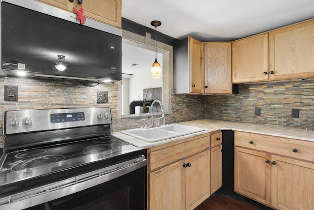 kitchen featuring a sink, decorative backsplash, stainless steel electric range oven, light brown cabinetry, and light countertops