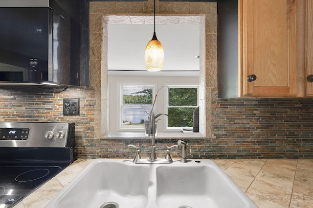 kitchen with hanging light fixtures, a sink, stainless steel range with electric stovetop, and decorative backsplash