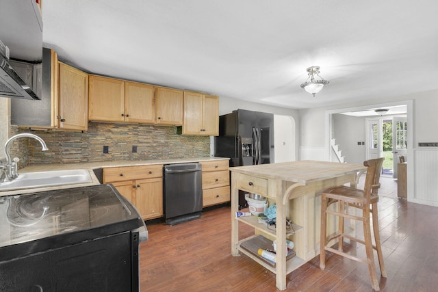 kitchen featuring decorative backsplash, light brown cabinetry, black appliances, a sink, and dark wood-type flooring
