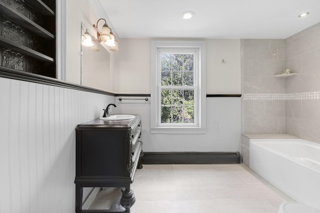 bathroom featuring recessed lighting, a tub, and vanity