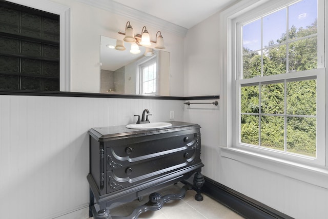 bathroom with a notable chandelier, tile patterned flooring, and vanity