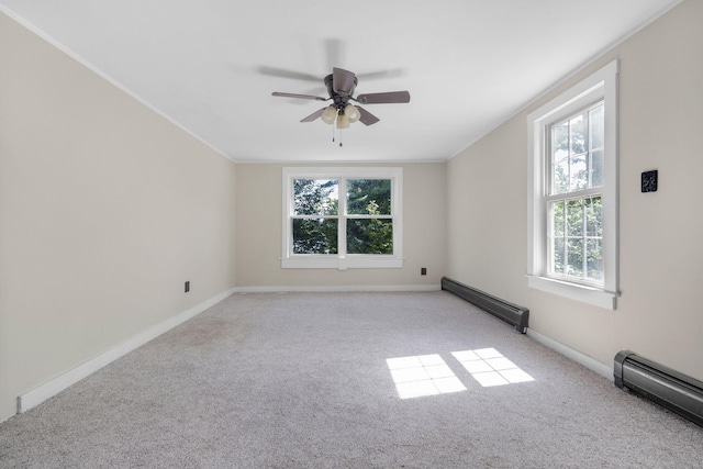 spare room with a healthy amount of sunlight, light carpet, and a baseboard radiator