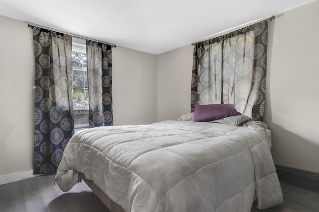 bedroom featuring wood finished floors and baseboards