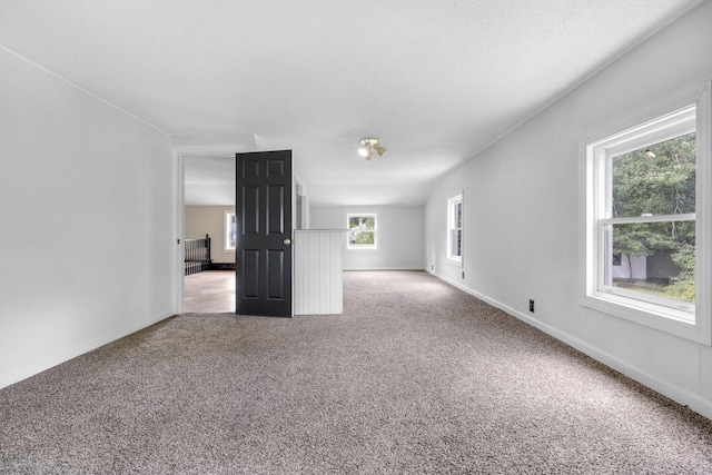 spare room with baseboards and light colored carpet