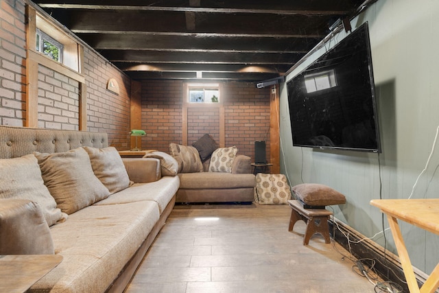living room with wood-type flooring and brick wall