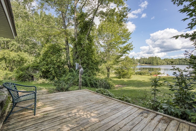 wooden terrace featuring a yard and a water view