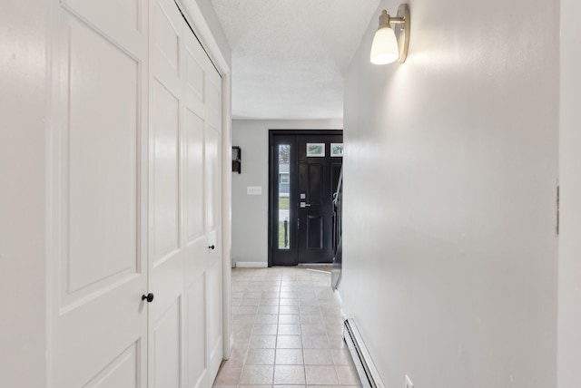 corridor featuring a baseboard radiator, baseboards, and light tile patterned floors