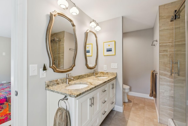 bathroom with double vanity, a sink, toilet, and a shower stall