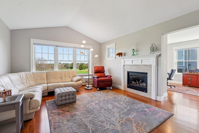 15 Callaway Dr Unit 15, Gray, ME 04039 - living area featuring a fireplace, vaulted ceiling, baseboard heating, and wood finished floors