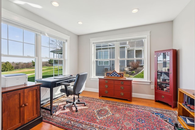 office space with baseboards, recessed lighting, and light wood-style flooring