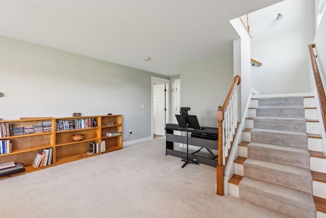 staircase featuring baseboards and carpet