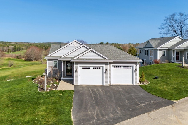 view of front facade with a garage, a shingled roof, driveway, and a front yard