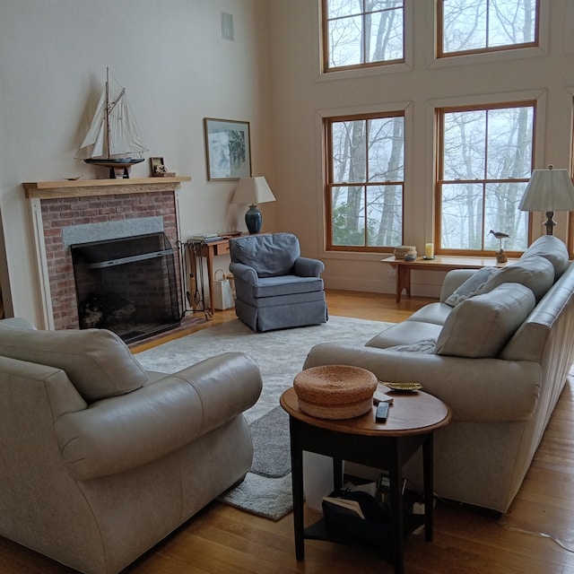 5 Southernpoint Rd, Bristol, ME 04564 - living room with healthy amount of natural light, light wood-style floors, a brick fireplace, and a high ceiling