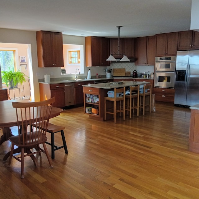 5 Southernpoint Rd, Bristol, ME 04564 - kitchen with stainless steel appliances, wood finished floors, a kitchen island, open shelves, and light countertops