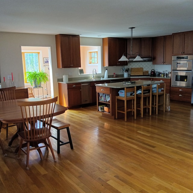 5 Southernpoint Rd, Bristol, ME 04564 - kitchen with under cabinet range hood, wood finished floors, a sink, and double oven