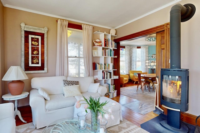 14 Water St, Vinalhaven, ME 04863 - living room with ornamental molding, a wood stove, and wood finished floors