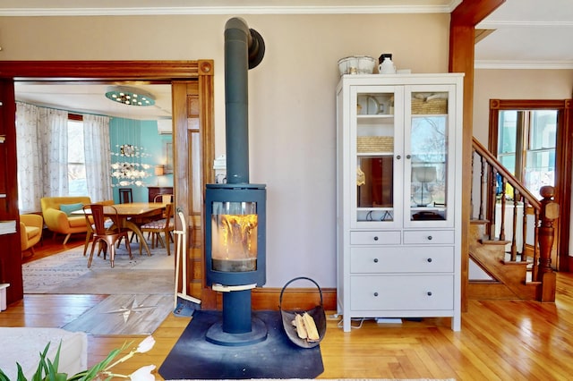 14 Water St, Vinalhaven, ME 04863 - room details with wood finished floors, a wood stove, and crown molding