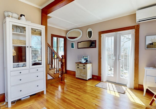 14 Water St, Vinalhaven, ME 04863 - doorway to outside with light wood-style flooring, a healthy amount of sunlight, a wall unit AC, and french doors