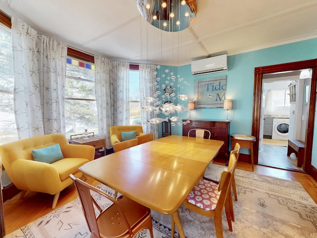 14 Water St, Vinalhaven, ME 04863 - dining space with a wall mounted air conditioner, ornamental molding, wood finished floors, and washer / clothes dryer