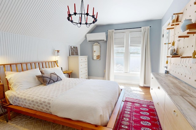 14 Water St, Vinalhaven, ME 04863 - bedroom with lofted ceiling, a wall mounted AC, a chandelier, and light wood-type flooring