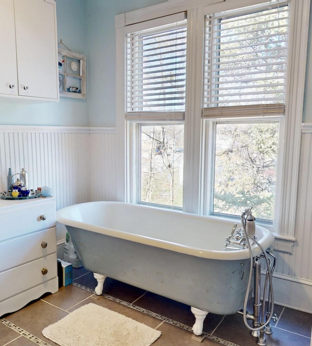 14 Water St, Vinalhaven, ME 04863 - bathroom featuring a soaking tub, a wainscoted wall, and tile patterned flooring