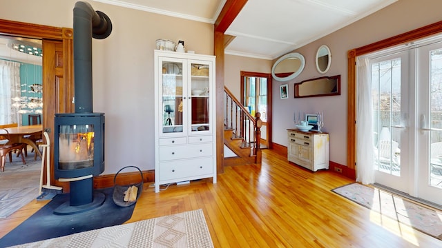 14 Water St, Vinalhaven, ME 04863 - foyer featuring stairway, crown molding, french doors, a wood stove, and light wood-style flooring
