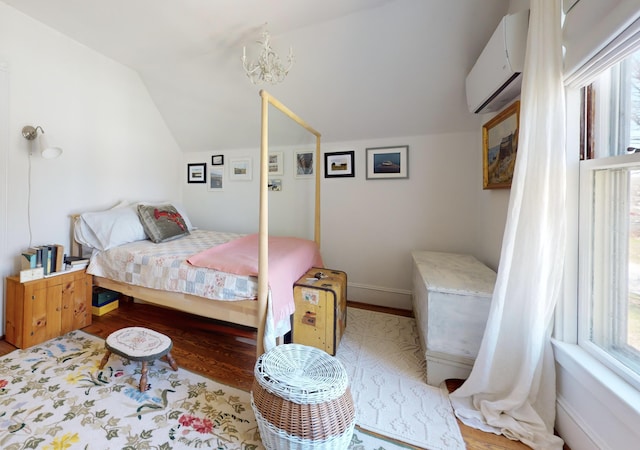 14 Water St, Vinalhaven, ME 04863 - bedroom featuring an AC wall unit, lofted ceiling, and wood finished floors