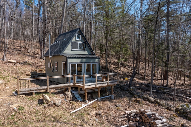 1 Good Day Dr, South Bristol, ME 04568 - rear view of property featuring metal roof, a wooded view, and a deck