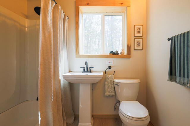 1 Good Day Dr, South Bristol, ME 04568 - bathroom featuring shower / bath combo, baseboards, a sink, and toilet