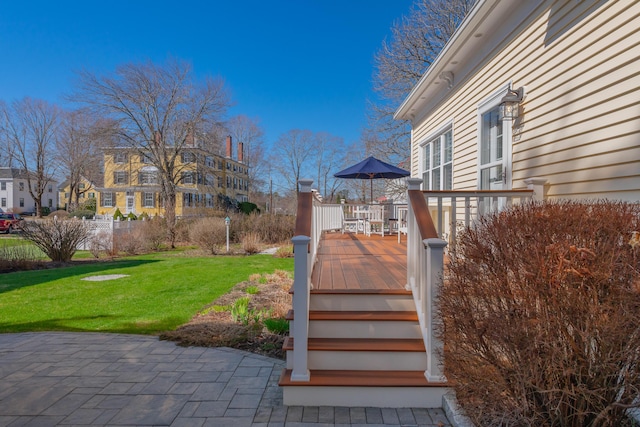 view of yard featuring a residential view and a deck