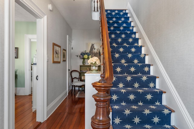 stairway with hardwood / wood-style floors